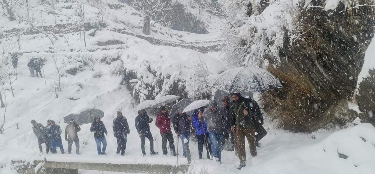 Administration officials walking by foot on snow in Tanta pyt (Doda district)