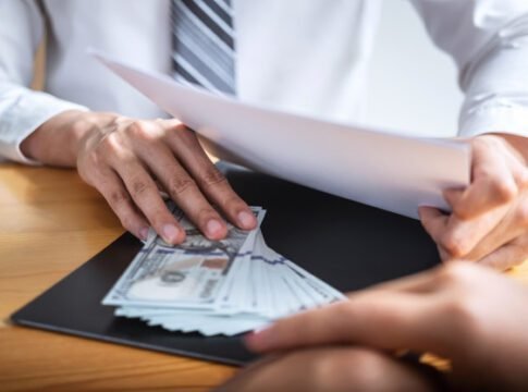 businessman-giving-bribe-money-business-people-give-success-deal-contract_122498-79