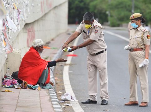 New Delhi police officers provide hand sanitizer to a homeless man on the third day of India’s national lockdown. RAJ K RAJ/HINDUSTAN TIMES/SIPA USA