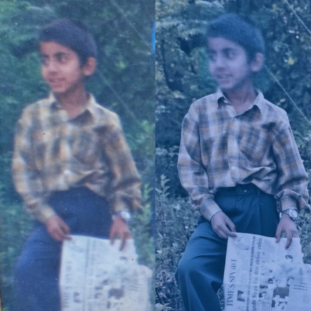 A boy (Anzer Ayoob) holding a newspaper in his hands, April 2005.