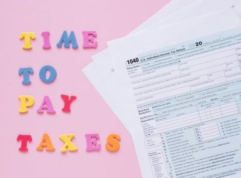 1040 tax forms with colorful 'Time to Pay Taxes' letters. 1040 tax forms with colorful 'Time to Pay Taxes' letters.