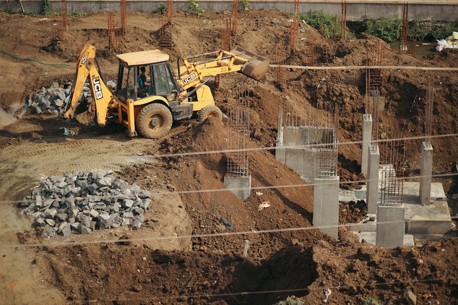 Jammu and Kashmir: Gauri Kaul Foundation Marks Five Years of Cardiac Care Expansion A bulldozer moves soil at a busy construction site, surrounded by piles of gravel and concrete structures.