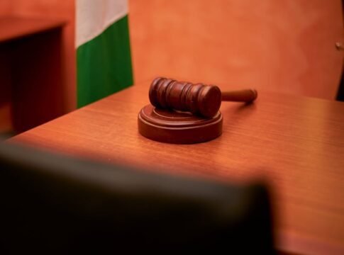 A close-up of a gavel on a courtroom desk representing law and justice. A close-up of a gavel on a courtroom desk representing law and justice.