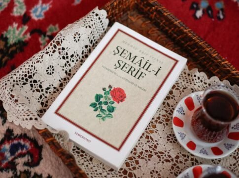 A cozy setting featuring Turkish tea served with a Semail-i Serif book on a decorative lace tray.