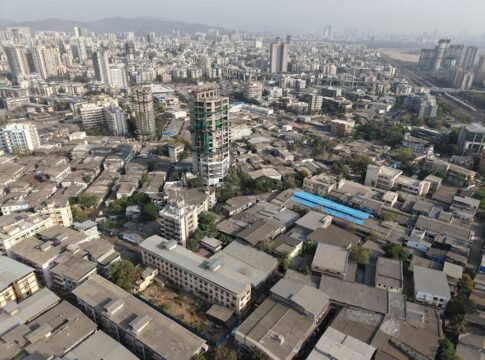 A high-angle view of Mumbai's sprawling urban landscape with a mix of buildings.