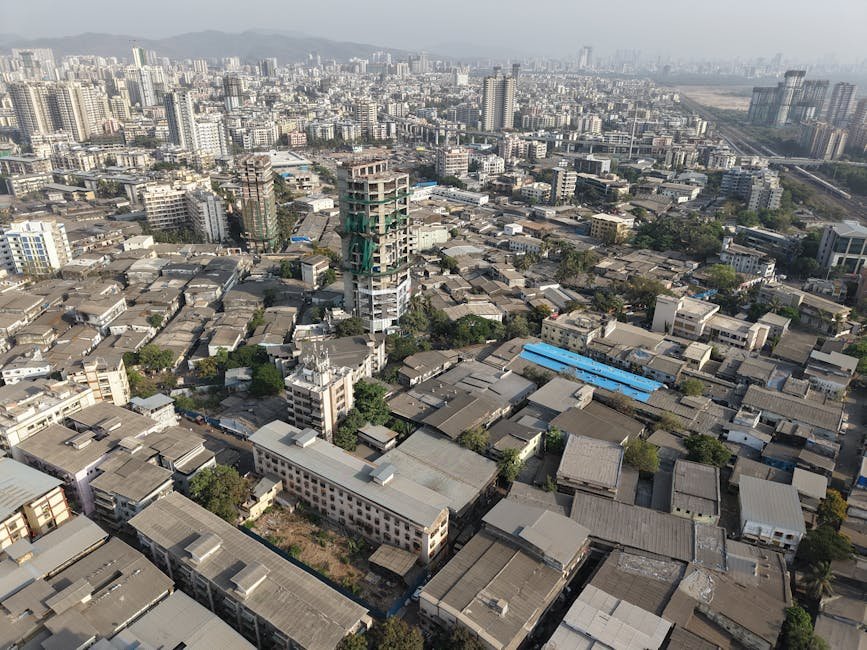 A high-angle view of Mumbai's sprawling urban landscape with a mix of buildings.