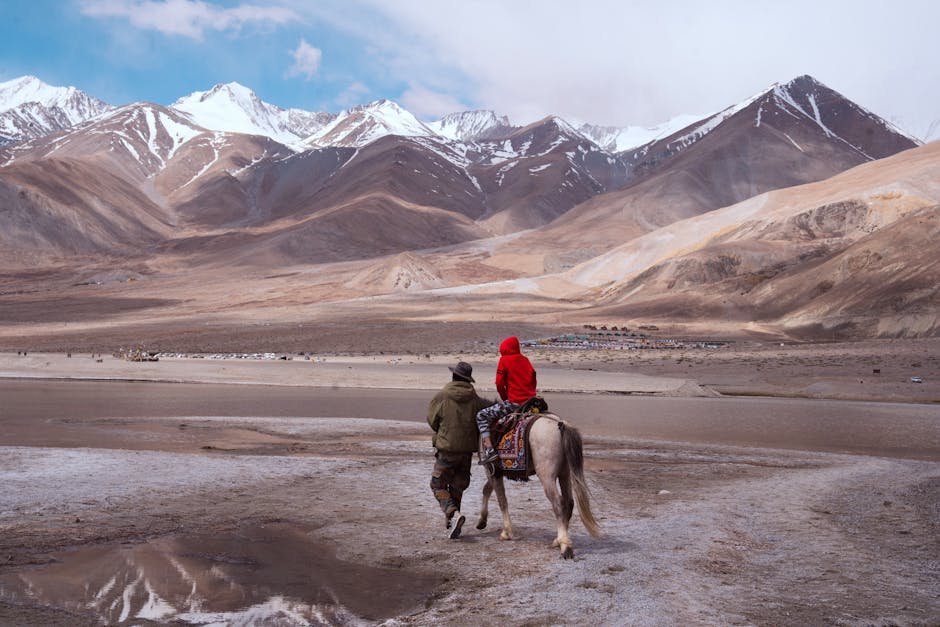 Jammu and Kashmir, Ladakh Heavily Rely on Thermal Power During Peak Winters A person and child riding a horse in the breathtaking mountains of Ladakh, India.