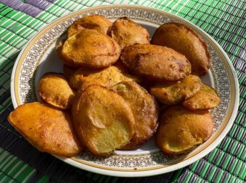 A plate of crispy golden pakoras, a traditional street food from Swat, Pakistan.