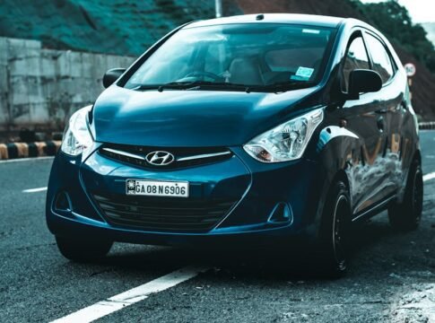 A vibrant blue Hyundai hatchback car parked on a scenic asphalt road, perfect for travel themes. A vibrant blue Hyundai hatchback car parked on a scenic asphalt road, perfect for travel themes.
