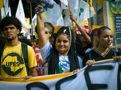 A vibrant youth protest with banners and flags, capturing activism in the urban environment. A vibrant youth protest with banners and flags, capturing activism in the urban environment.