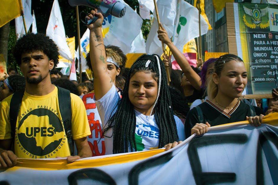 A vibrant youth protest with banners and flags, capturing activism in the urban environment. A vibrant youth protest with banners and flags, capturing activism in the urban environment.