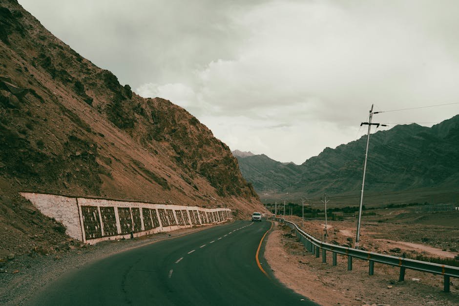 Ladakh Administration Approves Age Relaxation for Border Area Candidates in SI Recruitment A winding road leads through the rugged and scenic Ladakh mountains, capturing the essence of adventure travel.