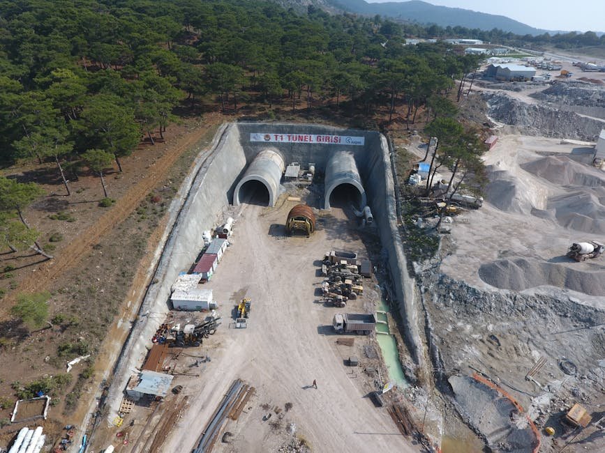 Ladakh Lieutenant Governor Reviews Zojila Tunnel Progress, Completion Expected by February 2028 Aerial shot of Yeniçam tunnel construction site in Çanakkale, Turkey, showcasing heavy machinery and forest surroundings.