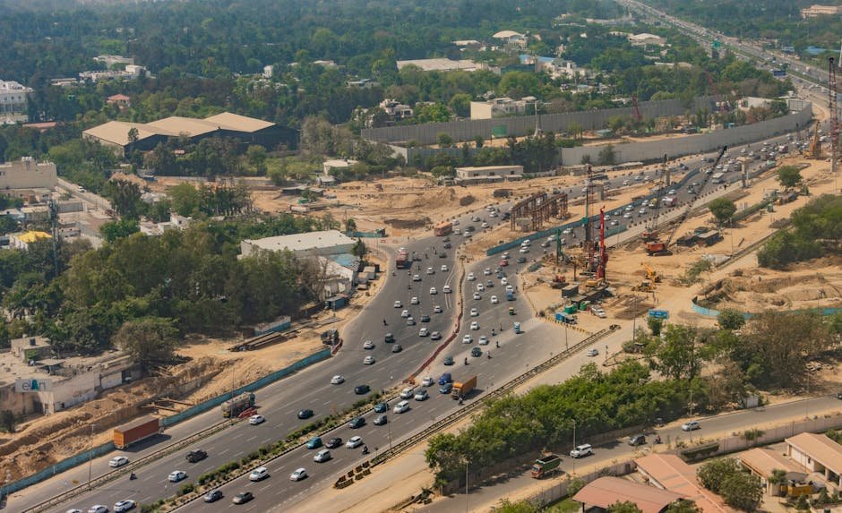 Delhi-NCR Highway Overhaul Promises 15-Minute Gurugram-Delhi Commute Aerial shot of busy expressway in New Delhi, showcasing traffic and city development.
