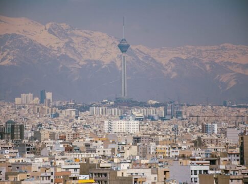 Aerial view of Tehran featuring Milad Tower against the Alborz Mountains. Aerial view of Tehran featuring Milad Tower against the Alborz Mountains.