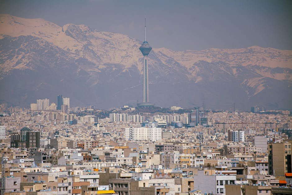 Iran Perceives US Demands in Pakistan Talks as Dictatorial, Not Negotiable Aerial view of Tehran featuring Milad Tower against the Alborz Mountains.