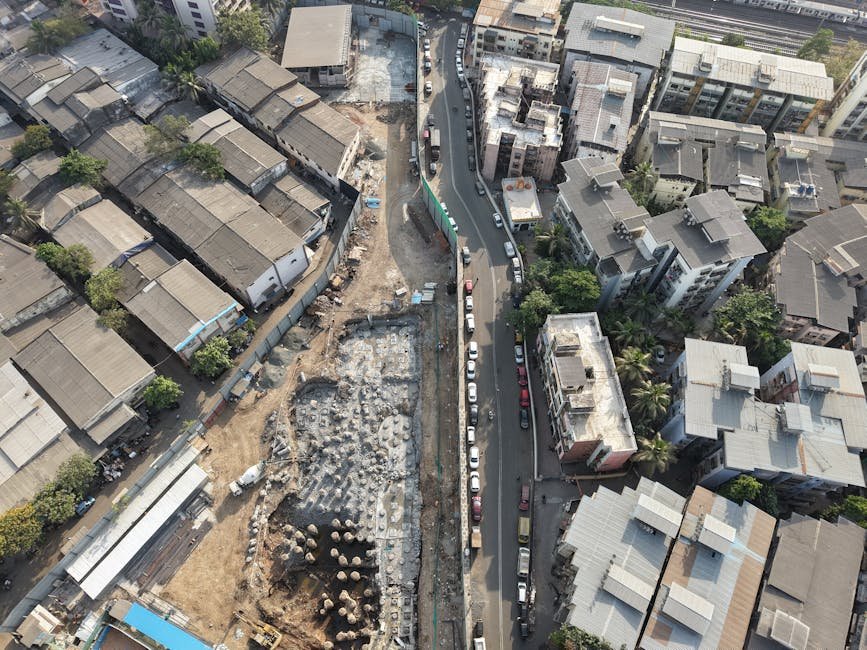 Aerial view of construction site amidst dense urban architecture in Mumbai, India. Aerial view of construction site amidst dense urban architecture in Mumbai, India.