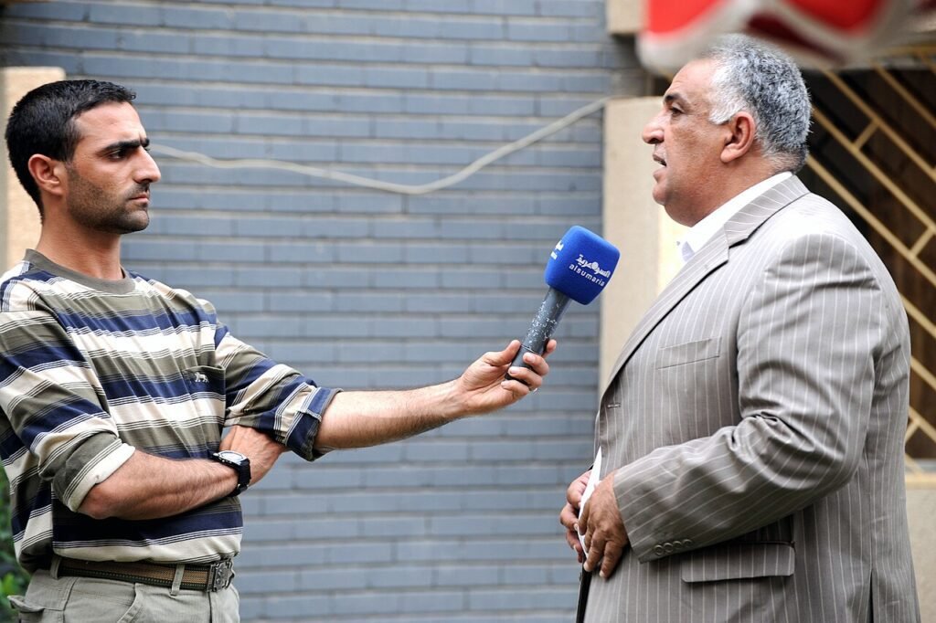 An Iraqi television journalist of the television network Alsumaria, left, interviews a construction contractor, responsible for renovations to the Alwaiya Maternity Hospital, at Muhallah 902, Karadah…