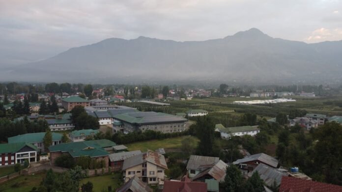Beautiful aerial view of Srinagar cityscape with lush greenery and distant mountains. Beautiful aerial view of Srinagar cityscape with lush greenery and distant mountains.