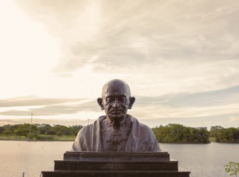 Bronze bust of Mahatma Gandhi with serene lake backdrop in Brasília, Brazil. Bronze bust of Mahatma Gandhi with serene lake backdrop in Brasília, Brazil.