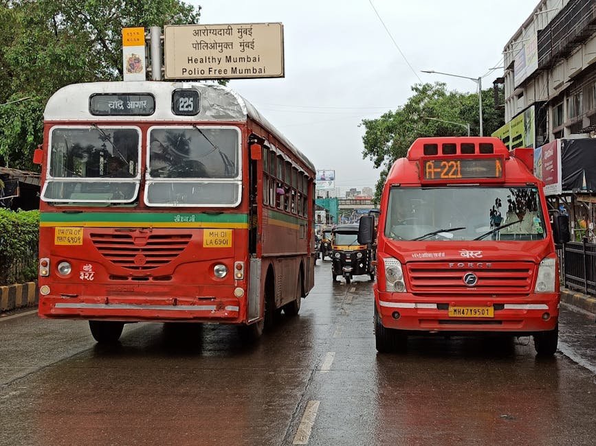 Buses and auto-rickshaws on a rainy Mumbai street, India.