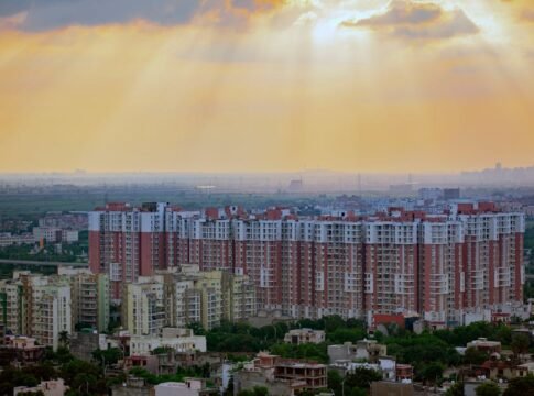 Captivating aerial view of Noida's residential skyline at sunrise, showcasing modern architecture and dramatic skies. Captivating aerial view of Noida's residential skyline at sunrise, showcasing modern architecture and dramatic skies.