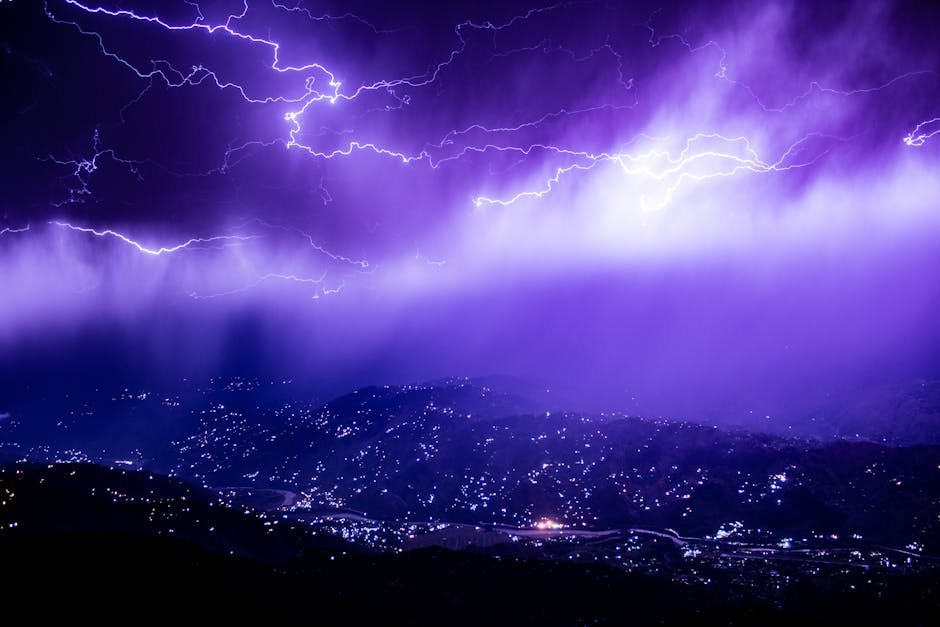 Captivating lightning storm over Muzaffarabad with a vivid purple sky, lighting up the mountains at night.