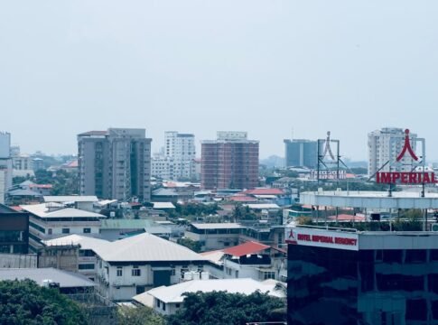 City view featuring the Imperial Regency Hotel and surrounding buildings under a clear sky.