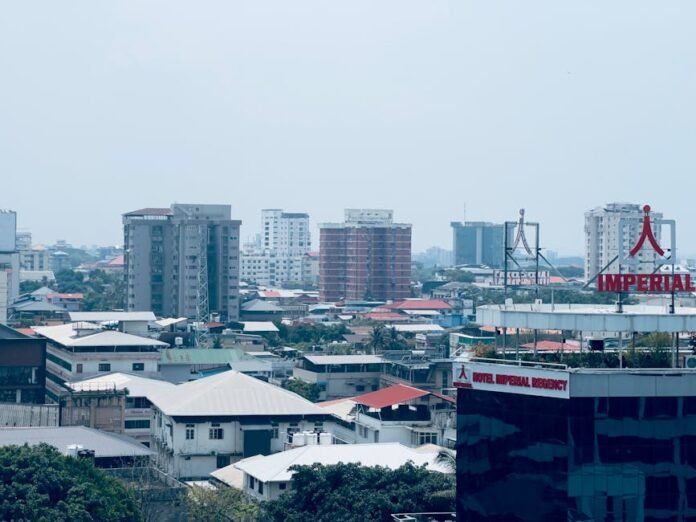 City view featuring the Imperial Regency Hotel and surrounding buildings under a clear sky.