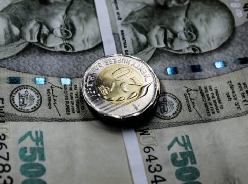 Close-up image of Indian rupee notes with a twenty rupee coin, illustrating financial themes. Close-up image of Indian rupee notes with a twenty rupee coin, illustrating financial themes.