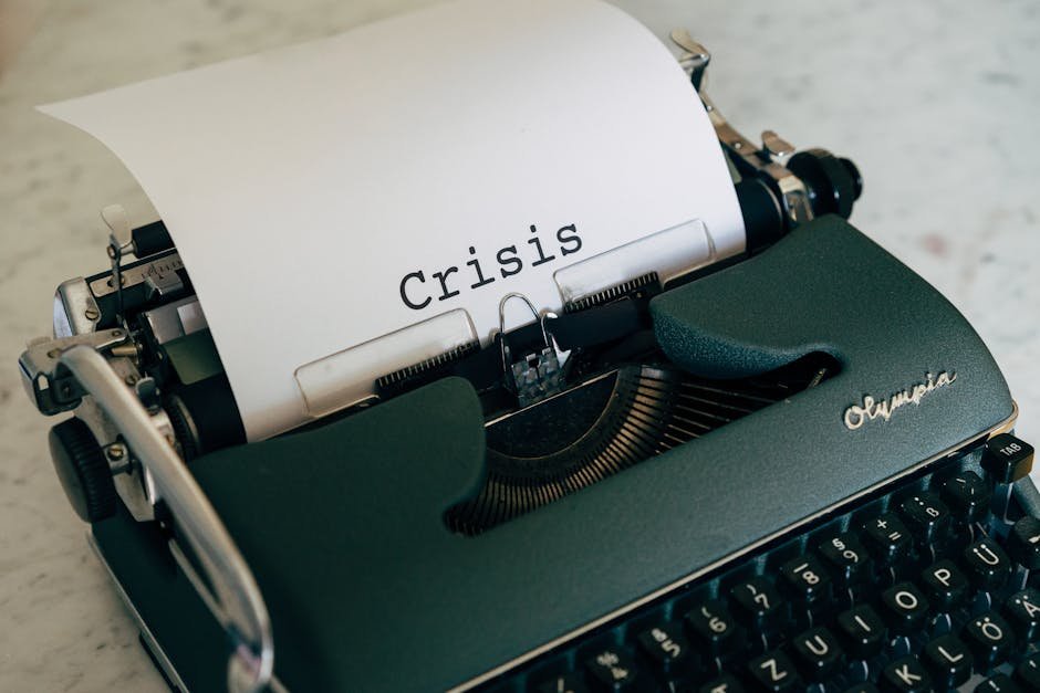 Close-up of a vintage typewriter with the word 'Crisis' typed on paper. Close-up of a vintage typewriter with the word 'Crisis' typed on paper.