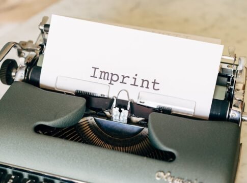 Close-up of a vintage typewriter with the word 'Imprint' on paper, evoking a classic retro feel.