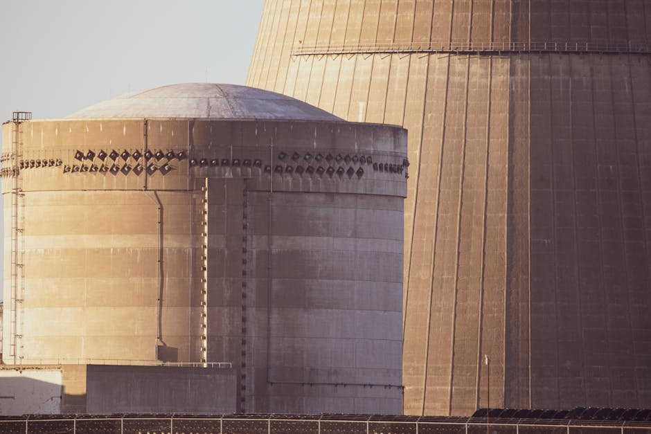 Close-up view of nuclear reactor buildings bathed in golden light, showcasing industrial architecture.