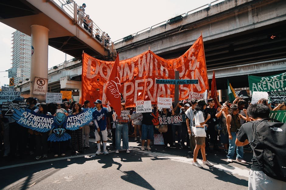 Jammu-Srinagar Highway Blocked for Four Hours by Protesters in Ramban Crowd of protesters with banners under a city overpass during daytime.