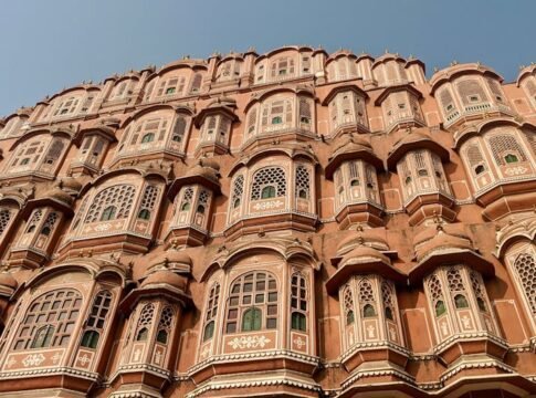 Detailed view of Hawa Mahal architecture with intricate windows in Jaipur, India.