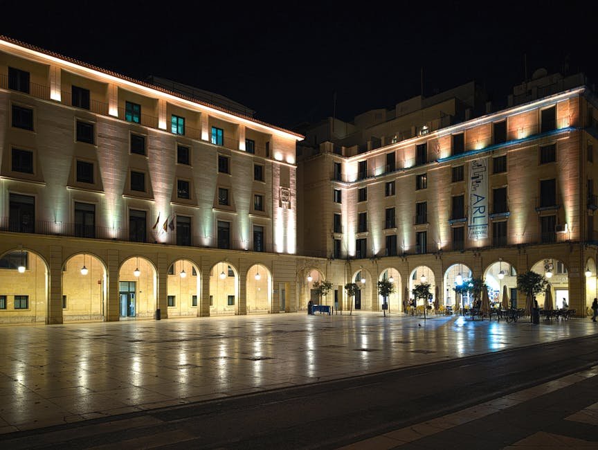 Elegant night view of Plaza de la Santísima Faz in Alicante, featuring illuminated historic buildings. Elegant night view of Plaza de la Santísima Faz in Alicante, featuring illuminated historic buildings.