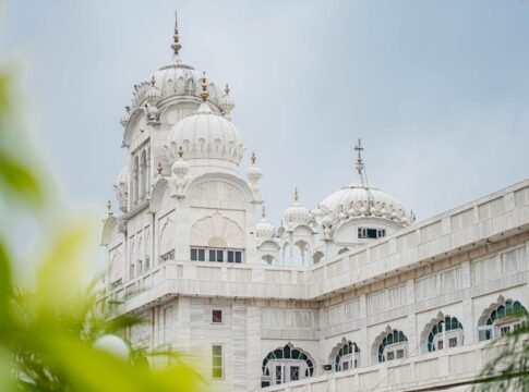 Elegant white temple with domes and intricate architecture in Ludhiana, India.