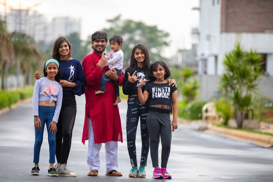Group of people posing outdoors with trendy outfits showcasing lively family spirit.