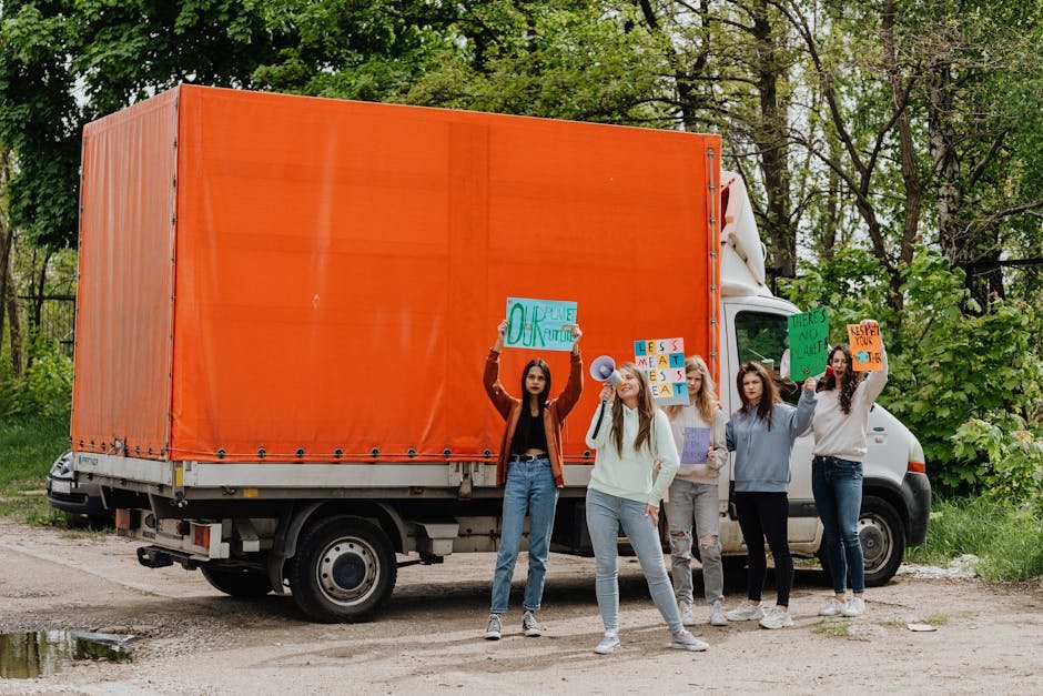 Ireland Fuel Protests Escalate, Government Engages Stakeholders Amid Shortage Fears Group of young women protesting outdoors with signs and banners by a truck.