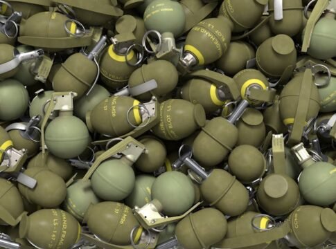 High-resolution image of olive green military hand grenades in a pile, showcasing industrial design.