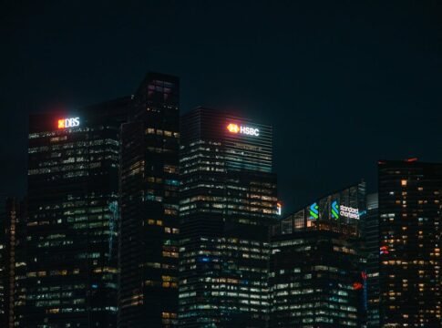 Illuminated city skyscrapers of major banks in Singapore's financial district at night. Illuminated city skyscrapers of major banks in Singapore's financial district at night.