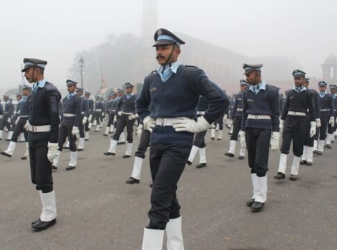 Indian military personnel marching in uniform during a foggy independence day parade.