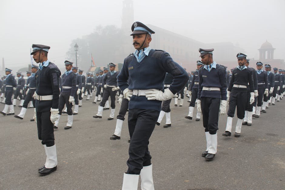 Indian military personnel marching in uniform during a foggy independence day parade.