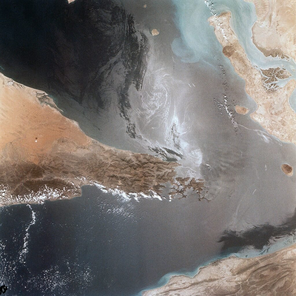 Portions of Oman, The United Arab Emirates and Iran are seen at the Strait of Hormuz (26.0N, 56.0E) in this view. A number of ship wakes can be seen in the area of the strait. Sunglint in the Persian…