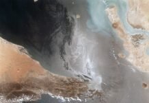 US and Iran Agree to Two-Week Ceasefire: A Fragile Step Toward De-Escalation in the Middle East Portions of Oman, The United Arab Emirates and Iran are seen at the Strait of Hormuz (26.0N, 56.0E) in this view. A number of ship wakes can be seen in the area of the strait. Sunglint in the Persian…