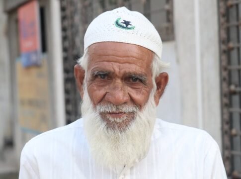Portrait of an elderly man wearing traditional Muslim attire, featuring a white cap and beard. Portrait of an elderly man wearing traditional Muslim attire, featuring a white cap and beard.