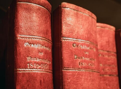 Red leather-bound parliamentary books from 19th century in Bern library, Switzerland.