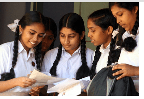 SSLC students evaluating question paper after examination.