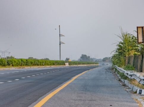 Serene landscape of an empty expressway in Deeg, India with lush greenery. Serene landscape of an empty expressway in Deeg, India with lush greenery.