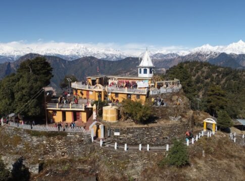 Stunning aerial view of Kartik Swami Temple surrounded by mountains in India.